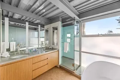 a bathroom with two sinks and a glass shower at Broad Beach Wdirect Beach Access in Malibu