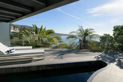a house with a swimming pool and a view of the water at Broad Beach Wdirect Beach Access in Malibu