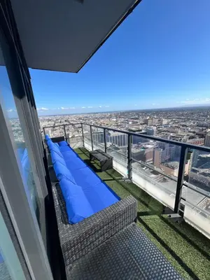 a balcony with a couch and a view of the city at 2BR Panoramic City View!! in Los Angeles