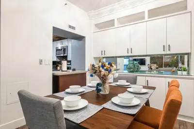 a kitchen and dining room with a table and chairs at Spacious 2 Bedroom Condo in DTLA, Large Private Patio, Pets Welcomed in Los Angeles