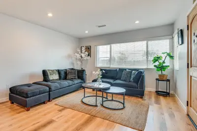 a living room with a couch and a table at 4 Mi to SoFi Stadium Modern Home with Fenced Yard in Los Angeles