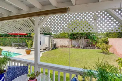 an outdoor patio with a pergola and a yard at Cozy Couples Oasis with Pool 3 Mi to Disneyland! in Garden Grove