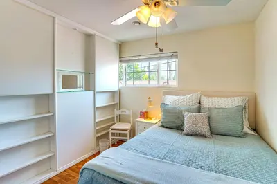 a small bedroom with a bed and a window at Cozy Couples Oasis with Pool 3 Mi to Disneyland! in Garden Grove