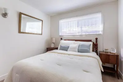 a white bedroom with a large bed and a window at Stylish2BR Patio BBQ Parking Downtown LA in Los Angeles