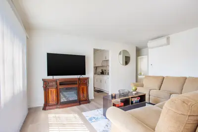 a living room with a couch and a flat screen tv at Stylish2BR Patio BBQ Parking Downtown LA in Los Angeles