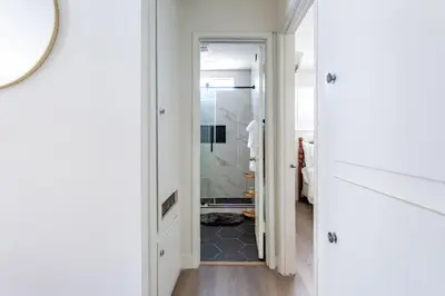 a hallway with a door leading to a bathroom at Stylish2BR Patio BBQ Parking Downtown LA in Los Angeles