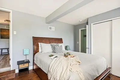 a bedroom with a large bed with a wooden headboard at Casa Huntsted A-Frame Cabin near Snow Valley in Running Springs