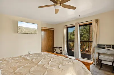 a bedroom with a bed and a large window at The Pinnacle steps to the ski lifts in Big Bear Lake