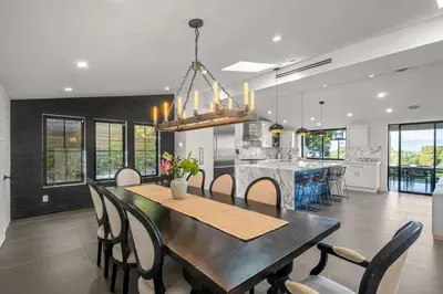 a dining room and kitchen with a table and chairs at Coulson Street Retreat with pool BBQ and more in Los Angeles