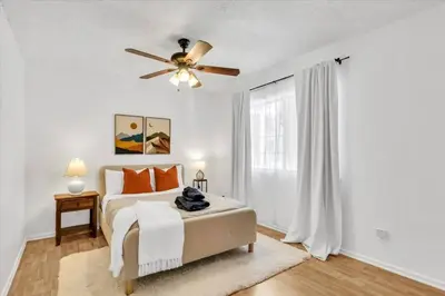a white bedroom with a bed and a ceiling fan at Peaceful, Los Angeles Family Vacation, Relocation Home in Los Angeles