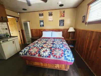 a bedroom with a bed with a quilt on it at Creek Runner Lodge in Big Bear Lake