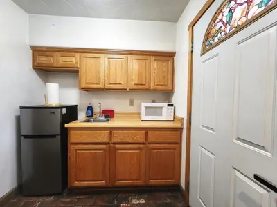 a kitchen with a black refrigerator and a microwave at Creek Runner Lodge in Big Bear Lake