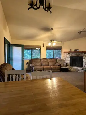 a living room with a couch and a table at Charming Pine Mountain Home with Family Space in Frazier Park