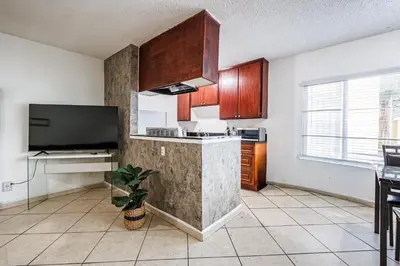 a kitchen with a counter and a tv in a room at Excellent 1BD Berryman#10 in Los Angeles