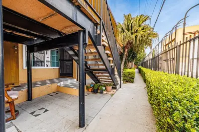 a building with a staircase next to a sidewalk at Excellent 1BD Berryman#10 in Los Angeles
