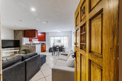 a living room with a couch and a kitchen at Excellent 1BD Berryman#10 in Los Angeles