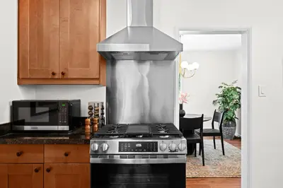 a kitchen with a stove and a microwave at Weho Sunset Strip Hideaway And Casita in Los Angeles