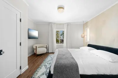 a white bedroom with a bed and a window at Weho Sunset Strip Hideaway And Casita in Los Angeles