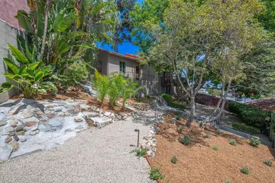 a garden in front of a house with trees at Weho Sunset Strip Hideaway And Casita in Los Angeles
