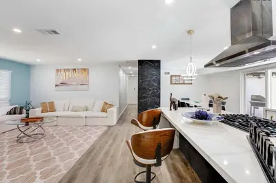 a kitchen and living room with a couch and a table at 4BR Escape - Mtn Views Private BBQ in Thousand Oaks