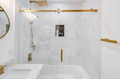 a white bathroom with a tub and a sink at 4BR Escape - Mtn Views Private BBQ in Thousand Oaks