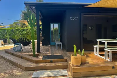 a house with a wooden deck with a table and chairs at Rad Stay Open Concept House in Mar Vista in Los Angeles