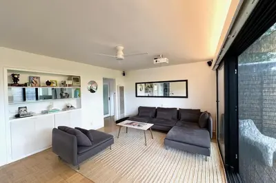 a living room with two couches and a table at Rad Stay Open Concept House in Mar Vista in Los Angeles
