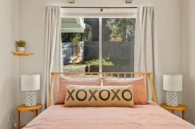 a bedroom with a bed with a large window at The Crown A-Frame Gated Central AC Lake Access in Lake Arrowhead