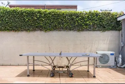 a ping pong table in front of a wall at Modern Studio with Private Patio in Los Angeles