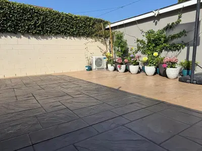 a patio with several pots of plants and flowers at Cute Studio with AC and Backyard in Los Angeles