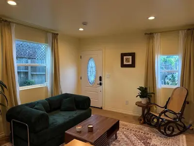 a living room with a green couch and a table at The Garden Escape in Los Angeles