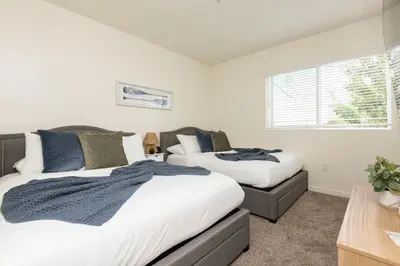 a bedroom with two beds and a window at Hollywood Stars 2 Bedroom Apartment in Los Angeles