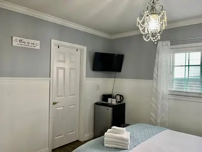 a bedroom with a bed and a television on the wall at Entire 4BR 4BA House in West Covina Modern Private Comfortable in West Covina