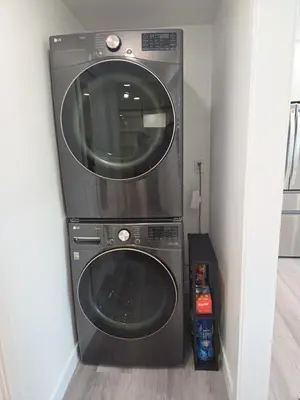 a washer and dryer in the corner of a room at Soft elegance, modern guest house in Alhambra