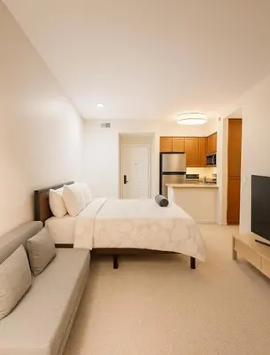 a bedroom with a large bed and a couch at Marina Del Rey Sunrise - Pool & Gym & Sauna & Cinema in Marina del Rey