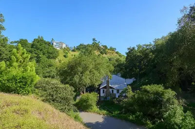 a house on a hill next to a river at Malibu Woods & Waves - 2 Bedroom in Malibu