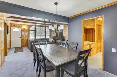 a dining room and living room with a table and chairs at Swim, Ski and Explore Cabin in Green Valley Lake! in Green Valley Lake