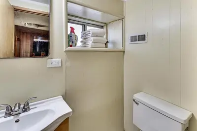 a bathroom with a sink and a mirror and a toilet at Swim, Ski and Explore Cabin in Green Valley Lake! in Green Valley Lake