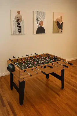 a large wooden foosball table in a room at Stylish 3BR Getaway plus Pool in Tarzana