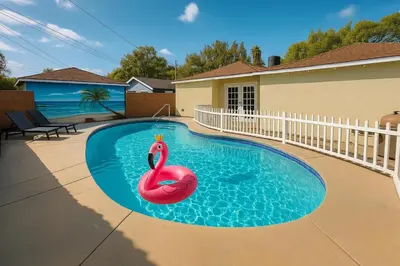 a swimming pool with a pink swan in it at Stylish 3BR Getaway plus Pool in Tarzana