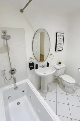 a bathroom with a tub and a sink and a toilet at Stylish 3BR Getaway plus Pool in Tarzana