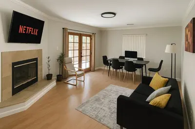 a living room with a couch and a fireplace at Modern Comfort near Universal in Los Angeles