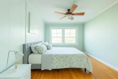 a bedroom with a bed and a ceiling fan at Fullerton Disneyland Getaway - 4BR in Fullerton