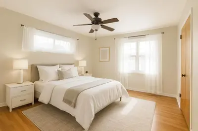 a bedroom with a white bed with a ceiling fan at Fullerton Adventure Basecamp - Short Trip To Disneyland in Anaheim