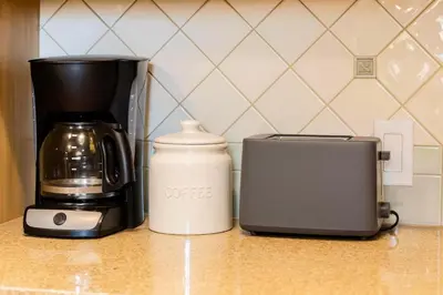 a coffee maker and a toaster on a counter at Fullerton Adventure Basecamp - Short Trip To Disneyland in Anaheim