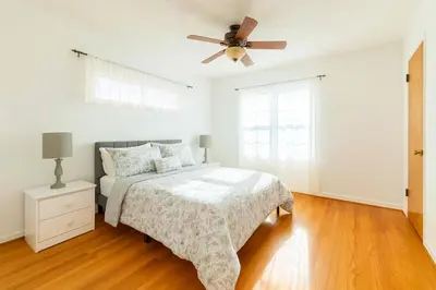 a bedroom with a bed and a ceiling fan at Fullerton Adventure Basecamp - Short Trip To Disneyland in Anaheim
