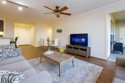 a living room with a couch and a tv at Marina del Rey Coastal 2BR Retreat- Pool, Hot Tub, Gym in Los Angeles