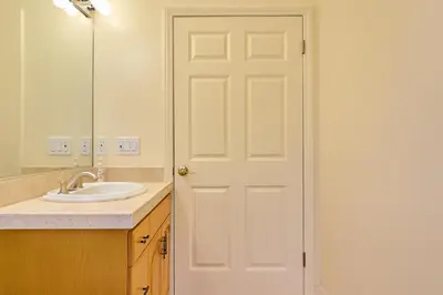 a bathroom with a white door and a sink at Malibu Beach - Nature 2BR Retreat in Malibu