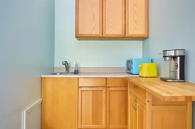 a kitchen with wooden cabinets and a sink at Malibu 2BR In Woods Close To Beach in Malibu