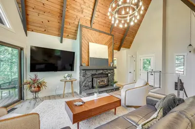 a living room with a couch and a fireplace at Stunning Forest Views Luxury Lake Arrowhead Cabin in Lake Arrowhead